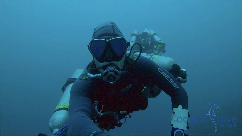 Two technical divers in blue water during a training dive